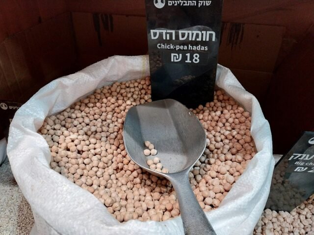 Chickpeas in an open sack with a scoop