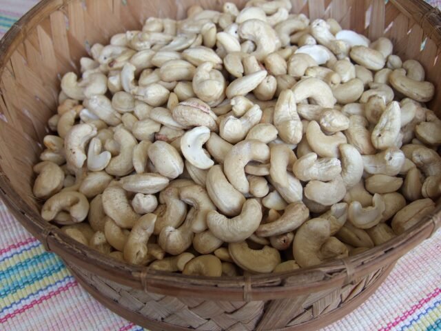 Whole white cashew kernels in a woven basket